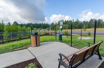 a park bench overlooking a park with a road in the background